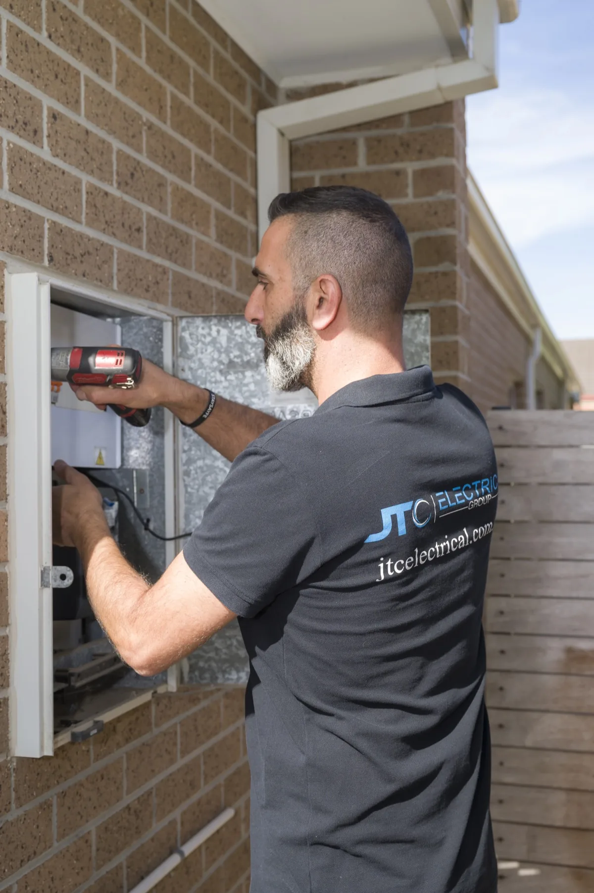Electrician working on meter box