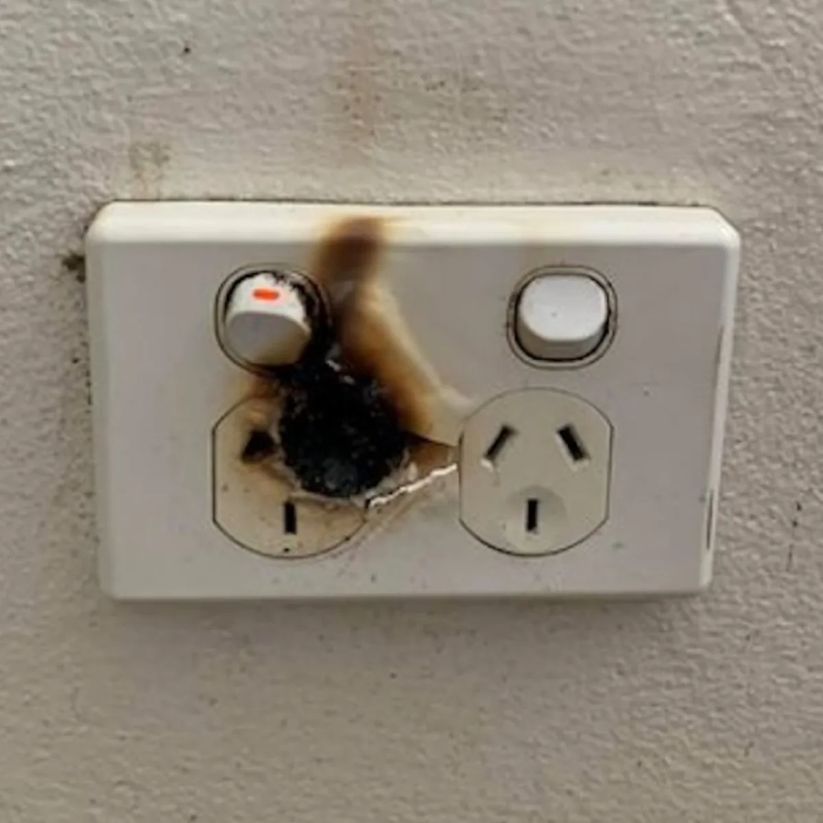 Burnt electrical outlet requiring emergency repair